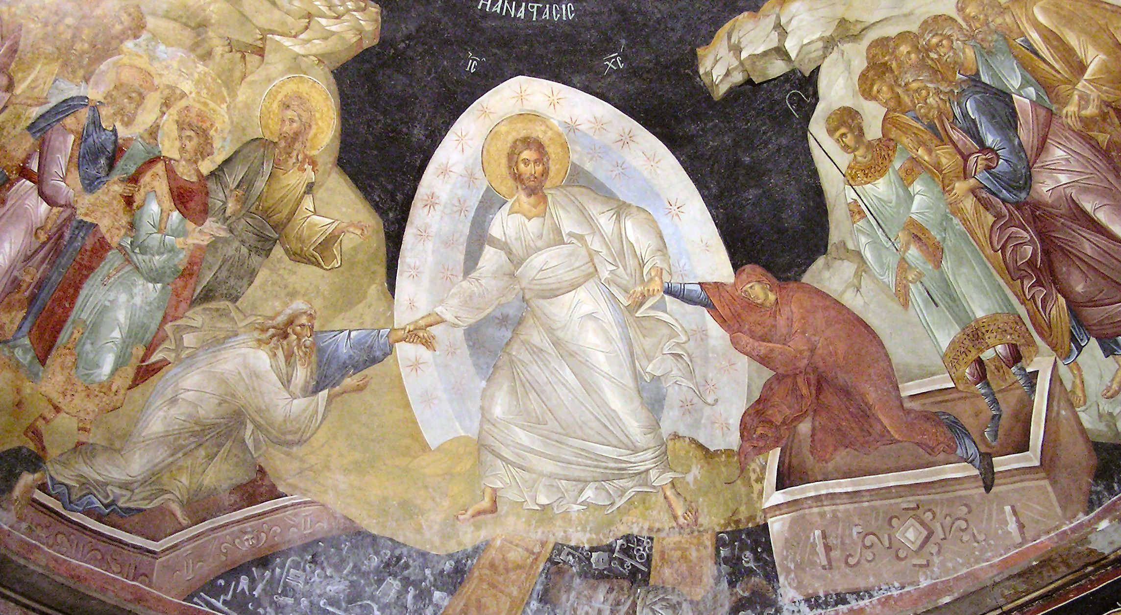 Having destroyed the gates of Hell, Jesus Christ is depicted flanked by saints, raising Adam and Eve from their graves and trampling death. Fresco of the resurrection at The Chora (c. 1315)
